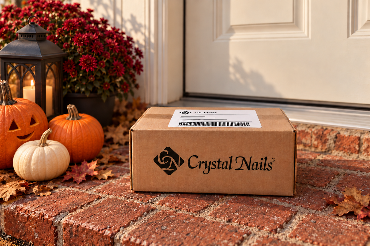 Crystal Nails delivery box on autumn brick steps beside pumpkins, with one subtle unlit carving